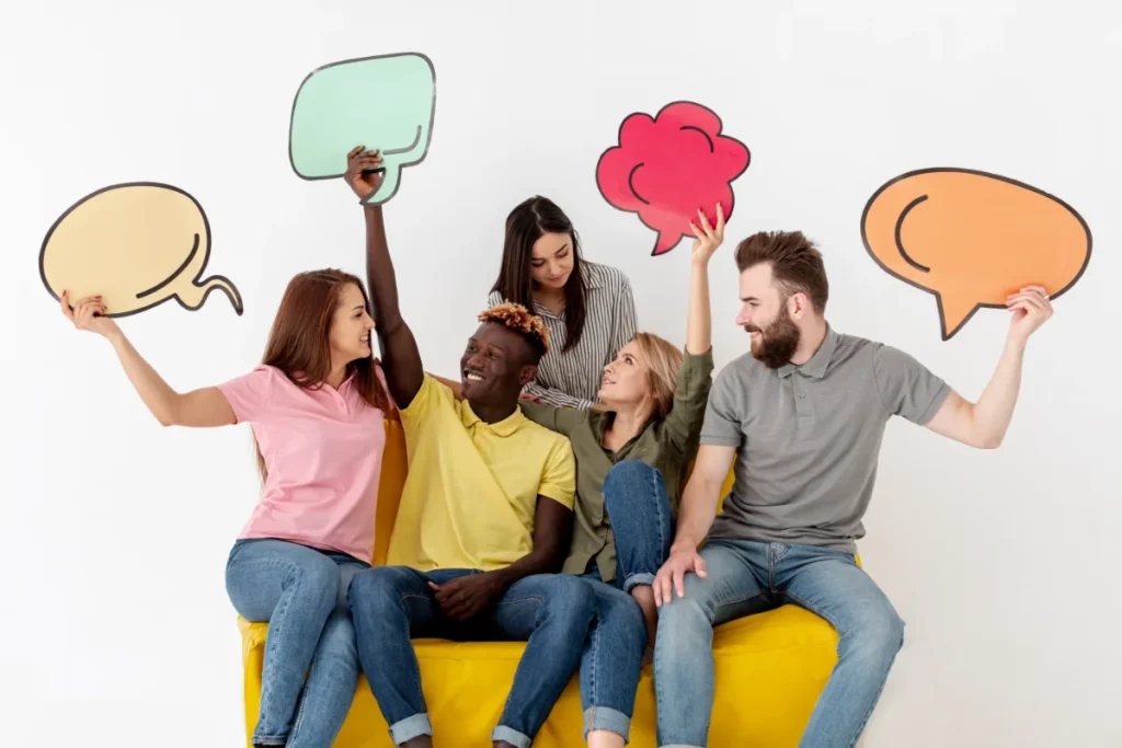 A group of people sitting on top of a yellow couch