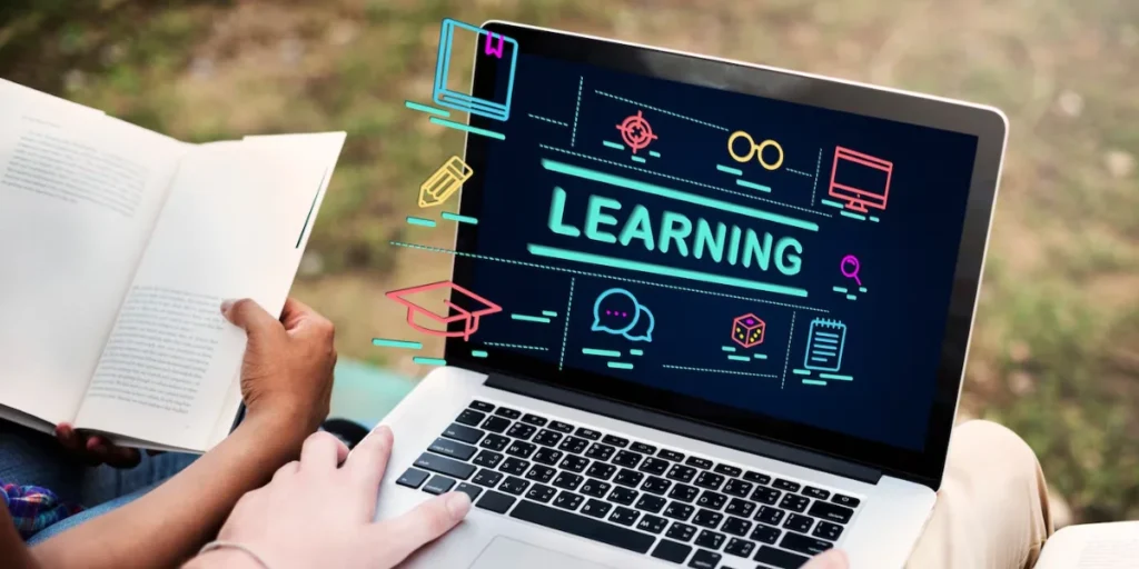Person using a laptop displaying vibrant educational graphics